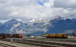 CN Jasper Yard, looking southeast towards the South Jasper Range, part of the Rockies, with W/B long, unit tank car train(3 hoppers separate the tank cars from the 4 CN locomotives, led by CN 3832.)